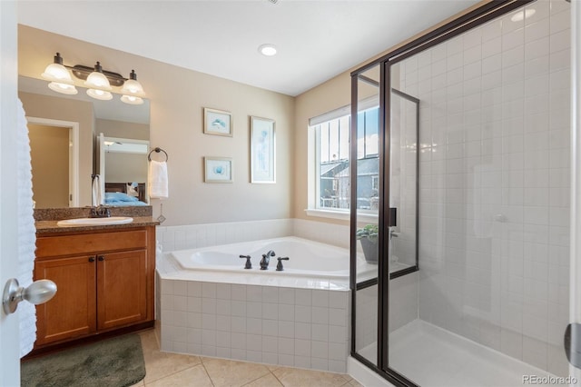 bathroom with tile patterned flooring, plus walk in shower, and vanity