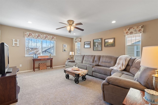 carpeted living room featuring ceiling fan and a healthy amount of sunlight