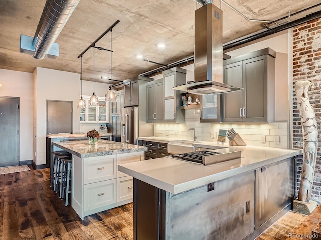 1401 Wewatta St Unit 308, Denver, CO 80202 - kitchen with a kitchen breakfast bar, dark wood-type flooring, a peninsula, a center island, and tasteful backsplash