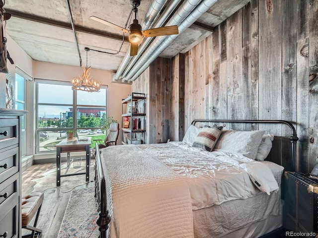 1401 Wewatta St Unit 308, Denver, CO 80202 - bedroom with wood walls, wood finished floors, a chandelier, and a view of city