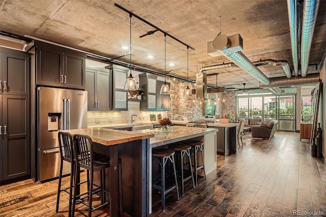 1401 Wewatta St Unit 308, Denver, CO 80202 - kitchen with high end refrigerator, a center island, wood counters, dark wood-type flooring, and island range hood