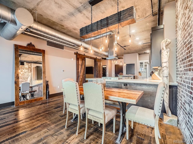 1401 Wewatta St Unit 308, Denver, CO 80202 - dining space featuring a barn door, wood finished floors, and brick wall