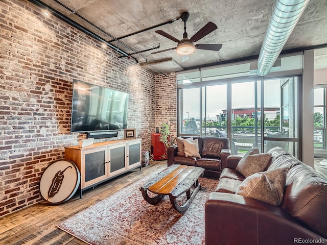 1401 Wewatta St Unit 308, Denver, CO 80202 - living area featuring hardwood / wood-style floors, ceiling fan, and brick wall
