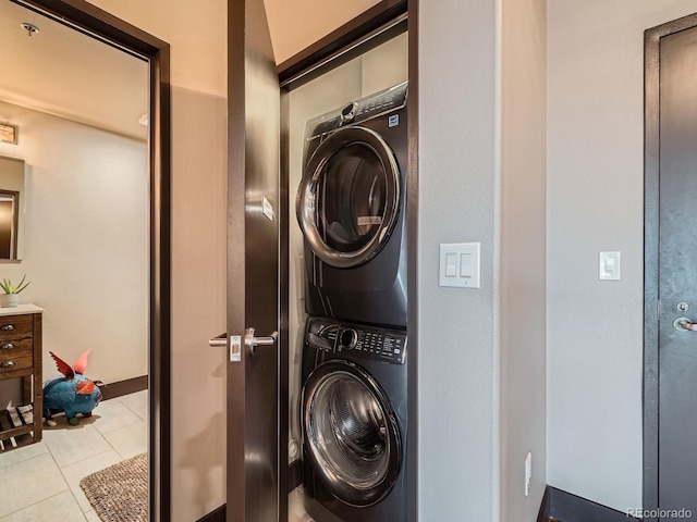 1401 Wewatta St Unit 308, Denver, CO 80202 - laundry room with stacked washing machine and dryer and tile patterned flooring