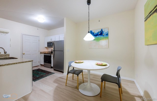 2428 W 82nd Pl Unit 3G, Westminster, CO 80031 - dining area with light wood-style flooring and baseboards