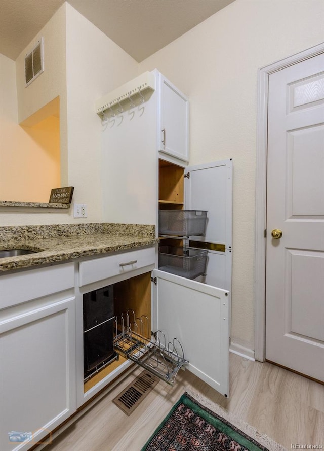 2428 W 82nd Pl Unit 3G, Westminster, CO 80031 - laundry room featuring light wood-style flooring and baseboards