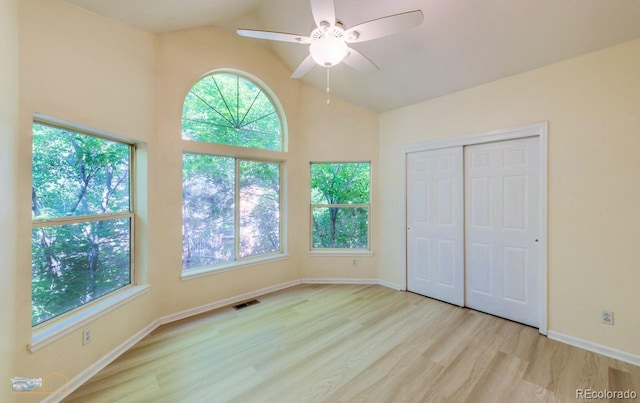 2428 W 82nd Pl Unit 3G, Westminster, CO 80031 - unfurnished bedroom featuring multiple windows, wood finished floors, vaulted ceiling, a closet, and a ceiling fan