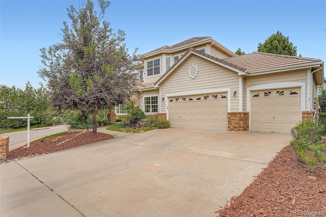 22019 E Arbor Dr, Aurora, CO 80016 - view of front of property featuring concrete driveway, a garage, a tiled roof, and brick siding