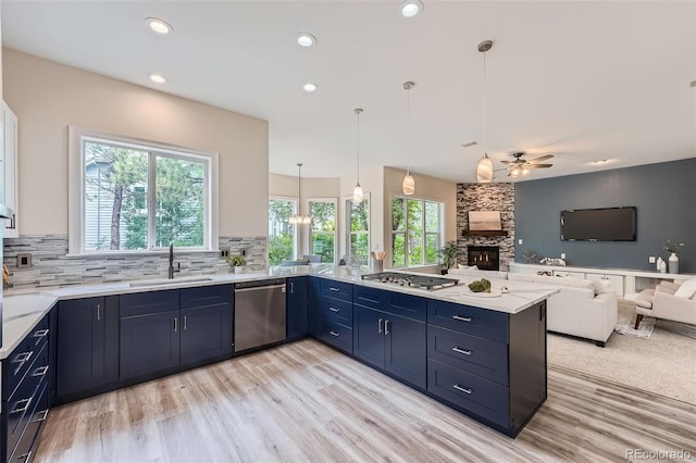 22019 E Arbor Dr, Aurora, CO 80016 - kitchen featuring stainless steel appliances, blue cabinets, open floor plan, a stone fireplace, and recessed lighting