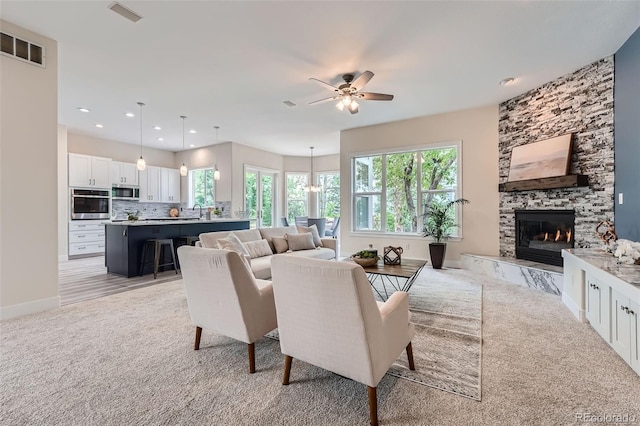 22019 E Arbor Dr, Aurora, CO 80016 - living room featuring light colored carpet, a fireplace, a ceiling fan, and recessed lighting