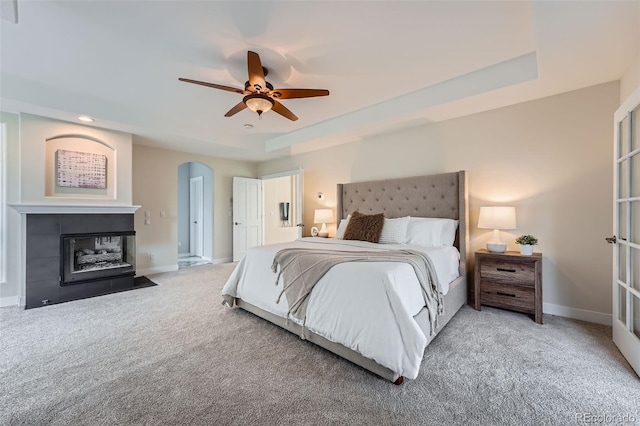 22019 E Arbor Dr, Aurora, CO 80016 - bedroom with carpet, a multi sided fireplace, a ceiling fan, recessed lighting, and arched walkways