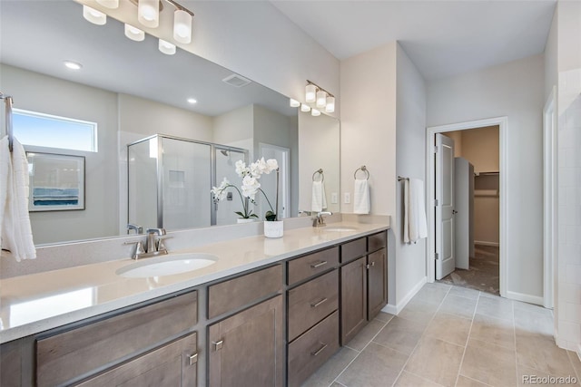 bathroom with vanity, tile patterned flooring, and a shower with door