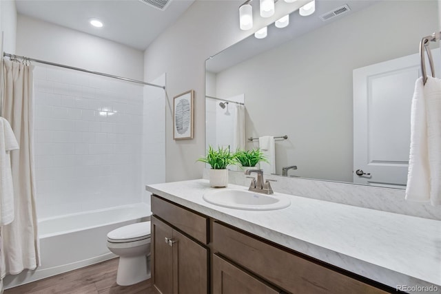 full bathroom featuring vanity, hardwood / wood-style floors, shower / bath combination with curtain, and toilet