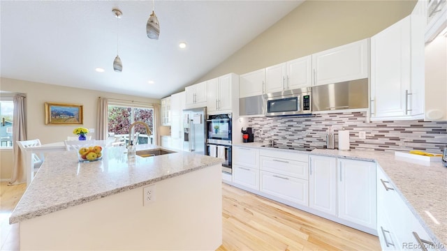 14833 Vine St, Thornton, CO 80602 - kitchen featuring a sink, stainless steel appliances, decorative backsplash, light wood-style flooring, and recessed lighting