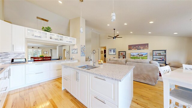 14833 Vine St, Thornton, CO 80602 - kitchen with a sink, light wood finished floors, high vaulted ceiling, open floor plan, and ceiling fan