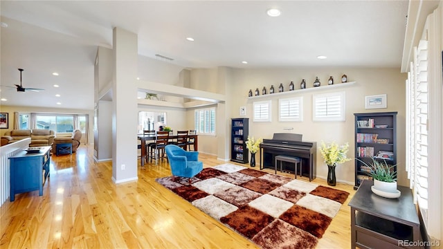 14833 Vine St, Thornton, CO 80602 - living room with vaulted ceiling, plenty of natural light, ceiling fan, wood finished floors, and baseboards