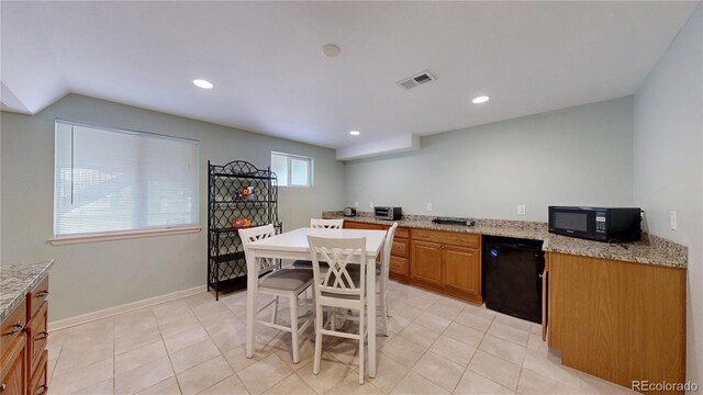 14833 Vine St, Thornton, CO 80602 - kitchen with black appliances, light tile patterned floors, brown cabinetry, light stone countertops, and recessed lighting