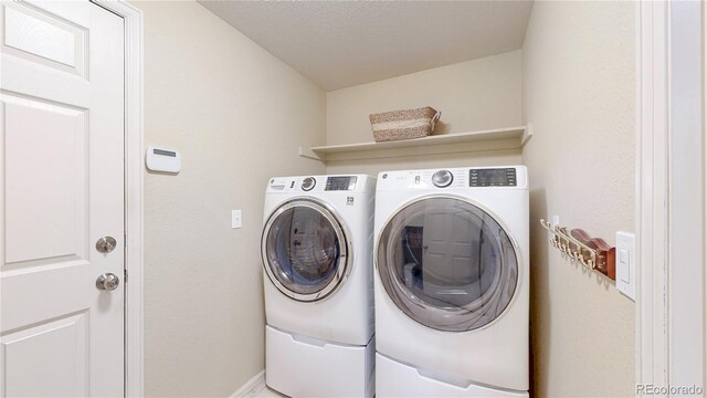 14833 Vine St, Thornton, CO 80602 - washroom featuring washer and clothes dryer and baseboards
