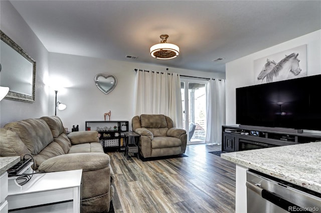 living room with visible vents and wood finished floors