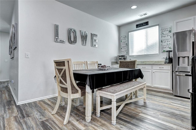 dining room with light wood-type flooring, baseboards, visible vents, and recessed lighting