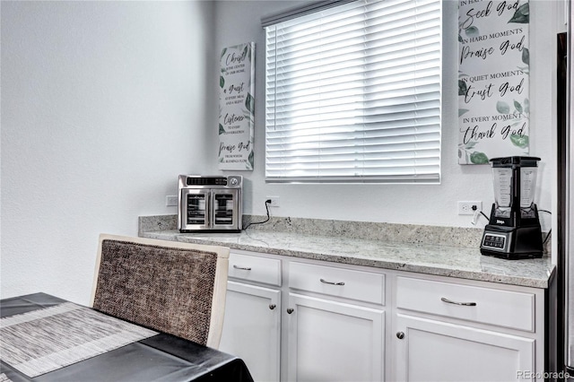 kitchen featuring white cabinets