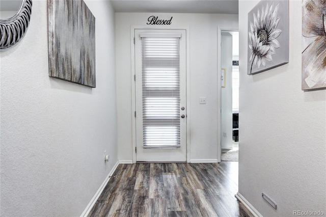 entryway with wood finished floors and baseboards