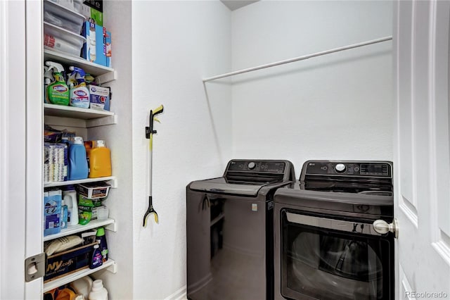 clothes washing area with washer and dryer and laundry area