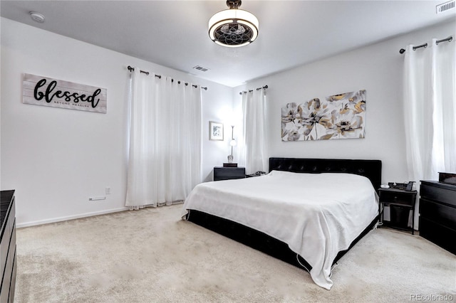 carpeted bedroom with baseboards and visible vents