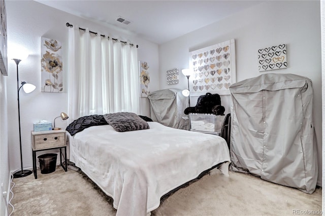 bedroom with visible vents and carpet flooring