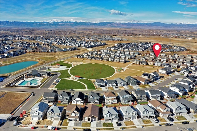 drone / aerial view featuring a water and mountain view and a residential view