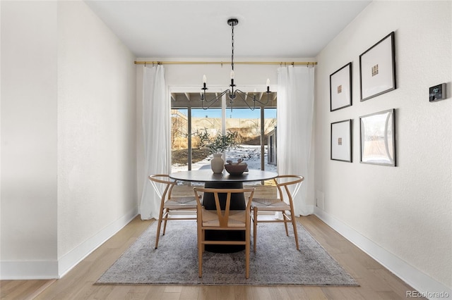 dining room featuring a chandelier and light wood-type flooring