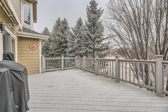 wooden deck with a grill