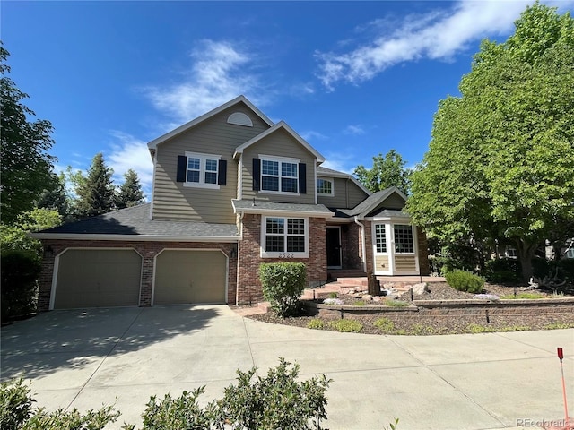 2522 W Dry Creek Ct, Littleton, CO 80120 - view of front of property featuring concrete driveway, brick siding, a shingled roof, and a garage