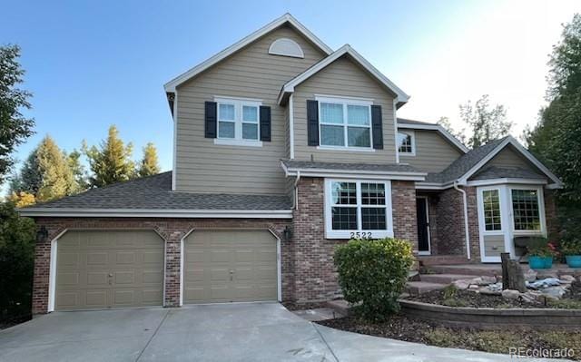 2522 W Dry Creek Ct, Littleton, CO 80120 - traditional home featuring brick siding, driveway, and roof with shingles