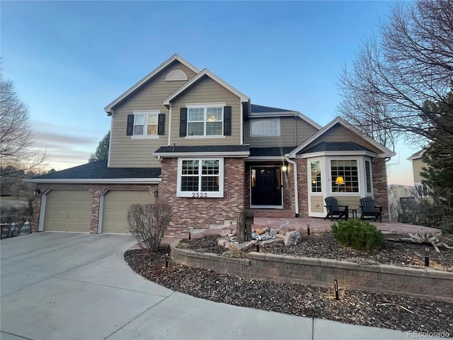 2522 W Dry Creek Ct, Littleton, CO 80120 - view of front of property with brick siding, concrete driveway, an attached garage, and roof with shingles