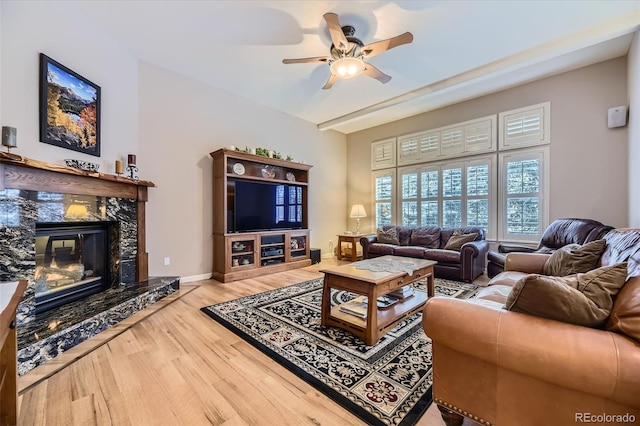 2522 W Dry Creek Ct, Littleton, CO 80120 - living room featuring a ceiling fan, wood finished floors, a high end fireplace, and baseboards