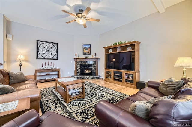 2522 W Dry Creek Ct, Littleton, CO 80120 - living room featuring ceiling fan, wood finished floors, a tiled fireplace, and baseboards