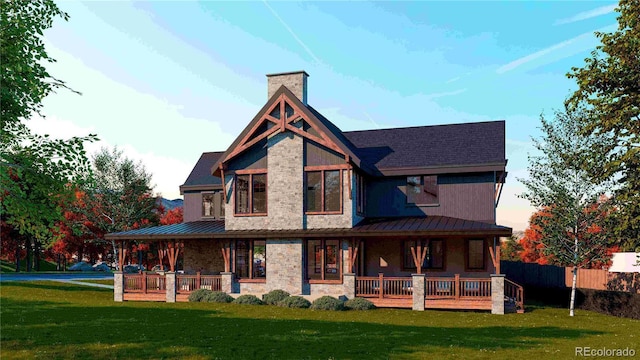 rear view of property featuring a lawn, covered porch, a chimney, and a standing seam roof