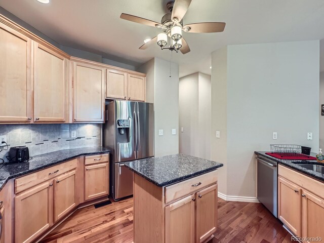13385 Jasmine St, Thornton, CO 80602 - kitchen with appliances with stainless steel finishes, light wood-style flooring, a ceiling fan, light brown cabinetry, and tasteful backsplash