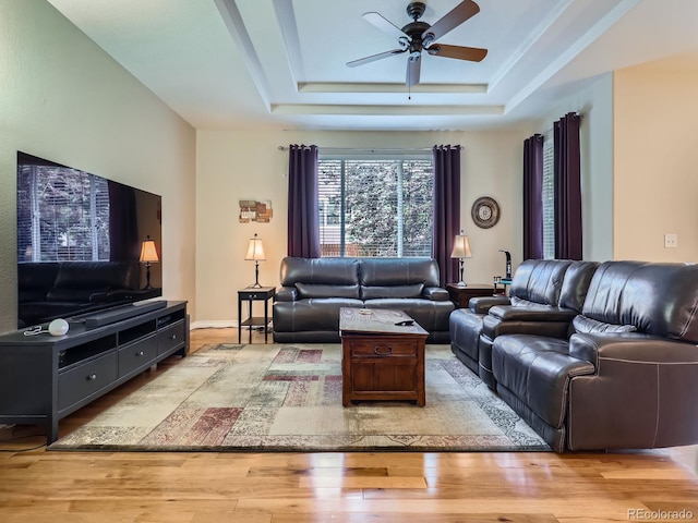 13385 Jasmine St, Thornton, CO 80602 - living area featuring ceiling fan, light wood-style floors, and a raised ceiling