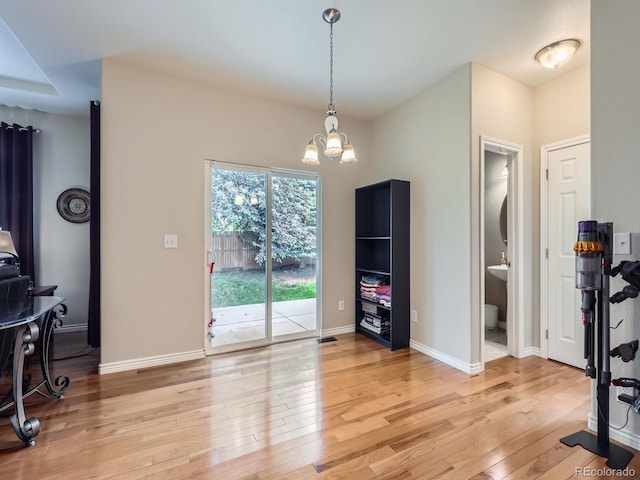 13385 Jasmine St, Thornton, CO 80602 - dining space featuring light wood-style flooring, a chandelier, and baseboards