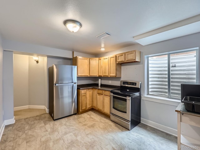 13385 Jasmine St, Thornton, CO 80602 - kitchen featuring stainless steel appliances, light brown cabinets, baseboards, dark countertops, and light flooring
