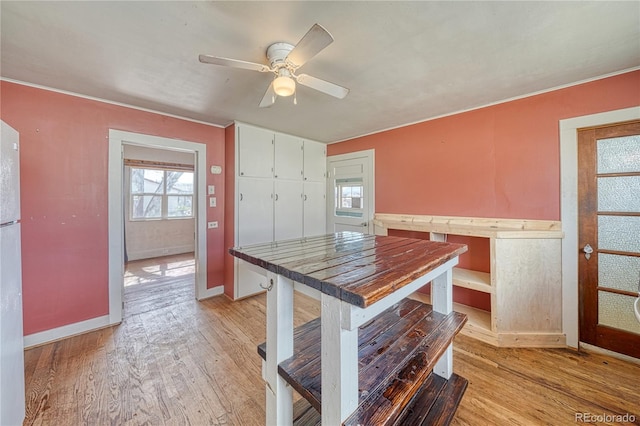 kitchen featuring plenty of natural light, light wood-style flooring, ceiling fan, and white cabinetry