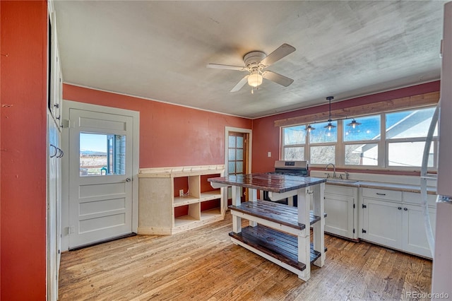 dining room featuring ceiling fan, light wood-style flooring, and plenty of natural light