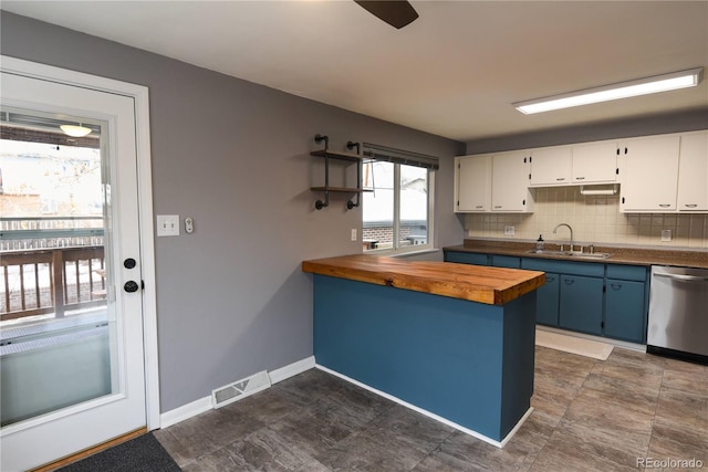 kitchen featuring blue cabinets, sink, wooden counters, stainless steel dishwasher, and white cabinets