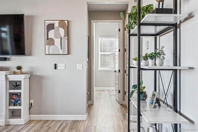 interior space with baseboards and wood finished floors