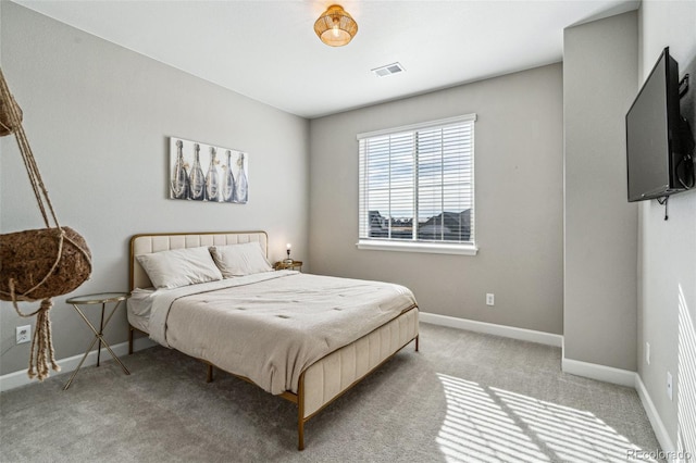 bedroom featuring light colored carpet, visible vents, and baseboards