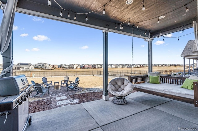 view of patio / terrace with fence and a grill