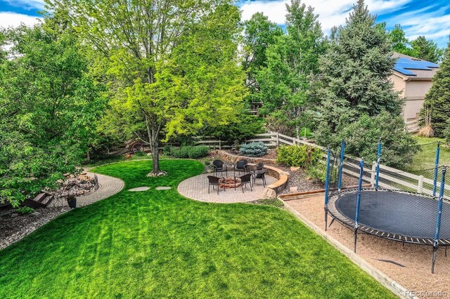 14118 Whitney Cir, Broomfield, CO 80023 - view of yard featuring a trampoline, an outdoor fire pit, and a patio