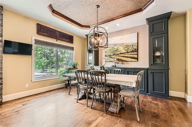 14118 Whitney Cir, Broomfield, CO 80023 - dining space featuring a raised ceiling, a chandelier, wood finished floors, ornamental molding, and recessed lighting